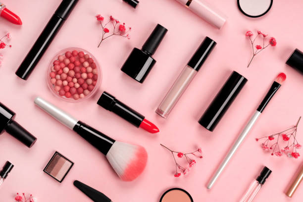 A range of cosmetic products with a pink background