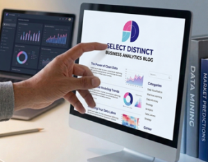 Hand pointing at a desktop monitor displaying Select Distinct Business Analytics Blog dashboard with charts and data visualisations.